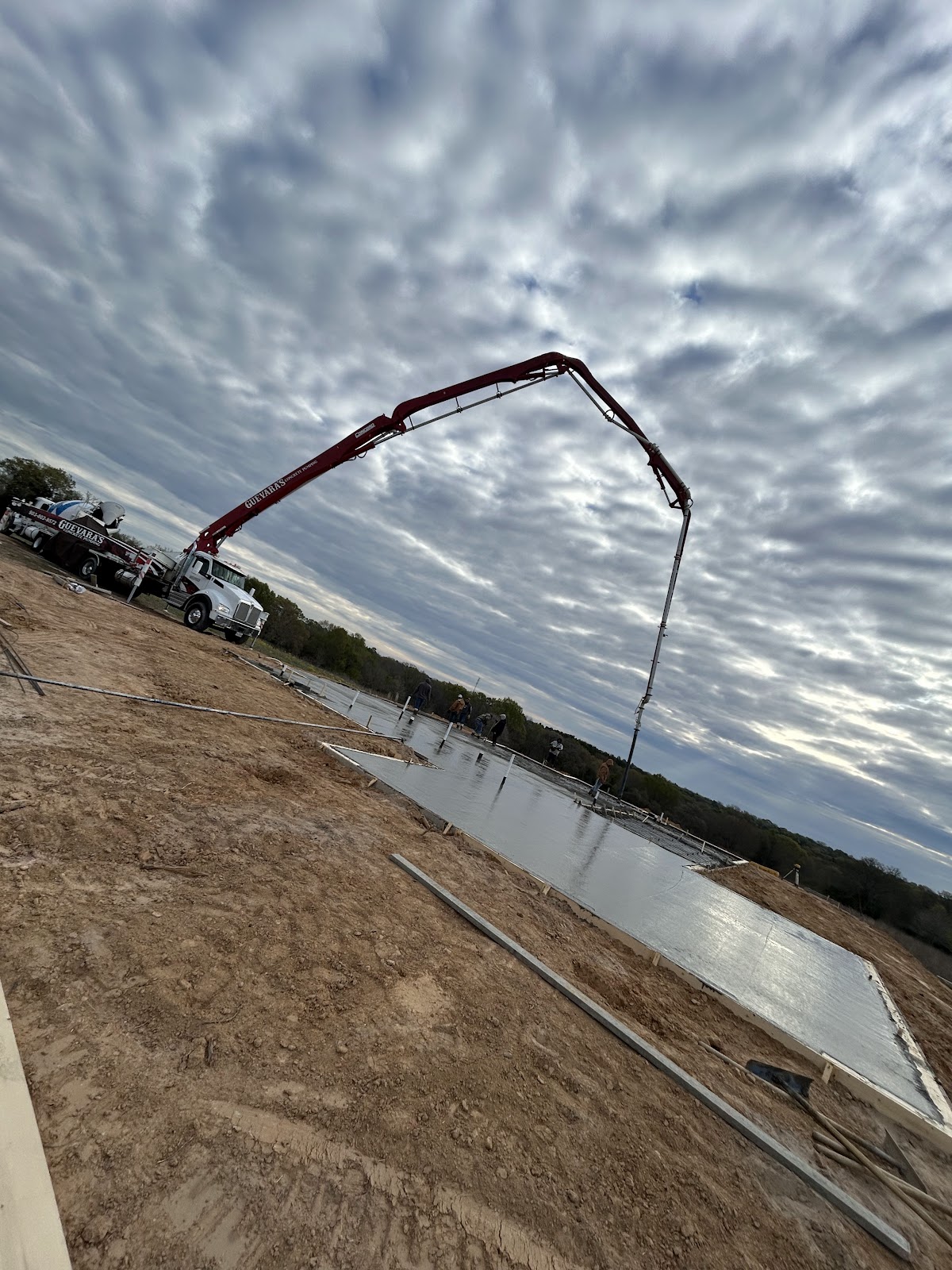 Concrete pump truck pouring a large slab