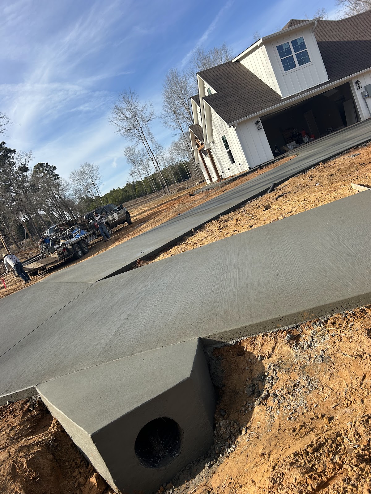 Wide concrete driveway and pad at a new home