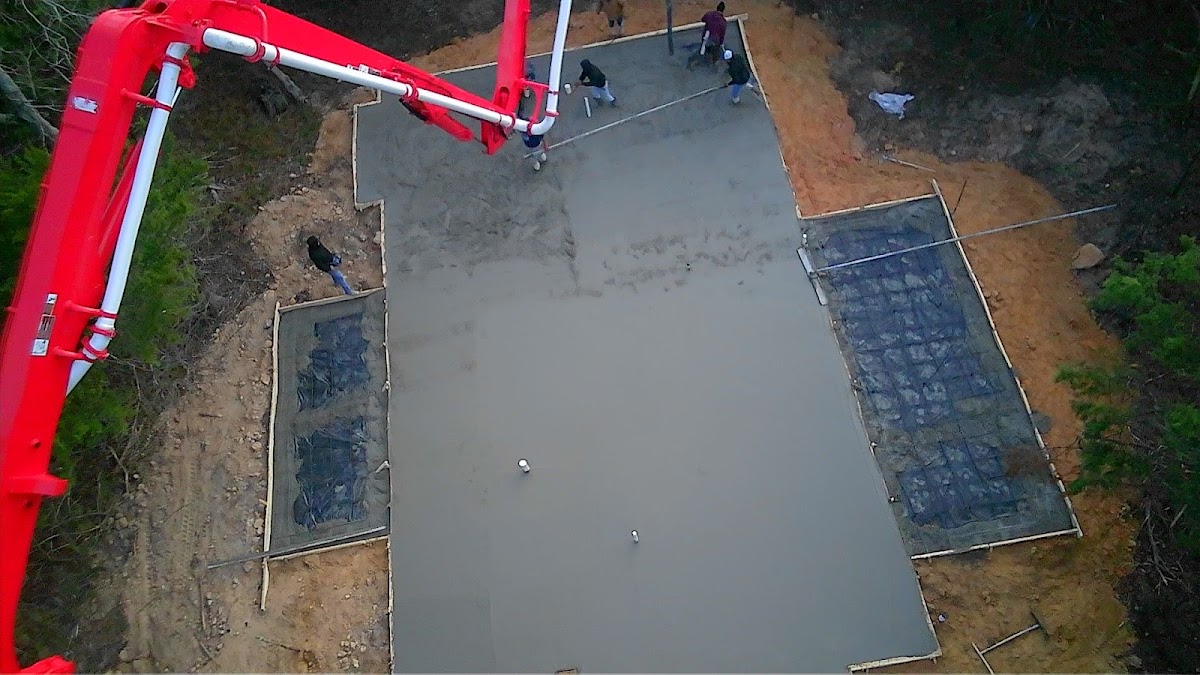 Aerial view of a slab being poured with the crew on site